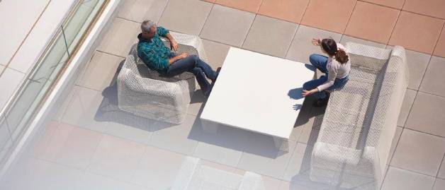 Two people talking in office lobby
