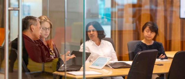 Meeting in office with glass walls