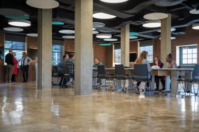 Groups of co-workers talking around a table
