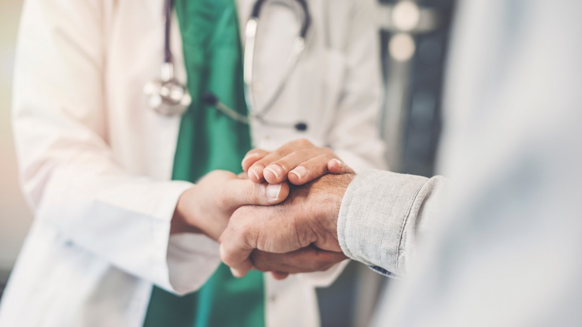 Doctor holding patient's hand