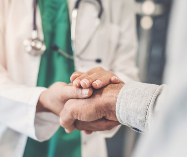 Doctor holding patient's hand