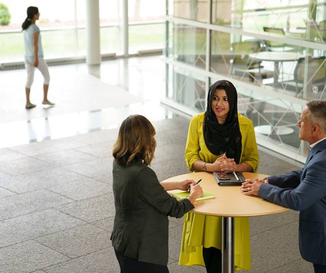 Diversity of employees around coffee table