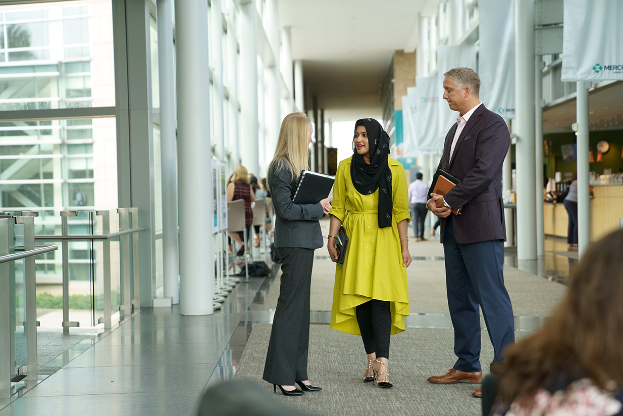 MSD Code of conduct - Diversity of employees walking in hallway