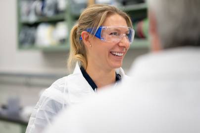 Scientist smiling with co-workers